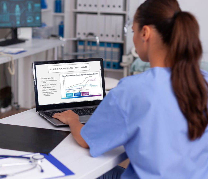 Doctor watching Grayken Center pre-recorded training slideshow on a laptop computer